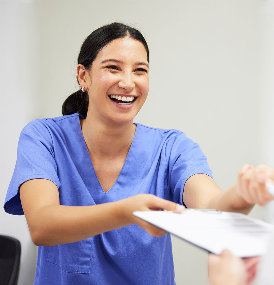 staff member helping patient with check in process