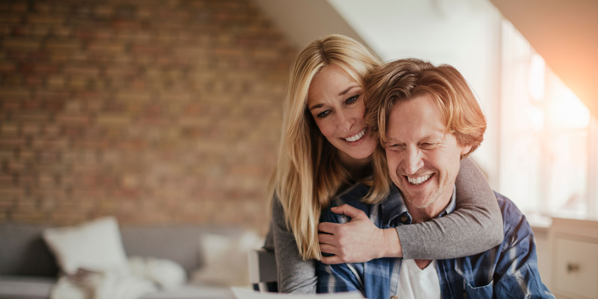 Mature couple going over their finances and bills at home while budgeting