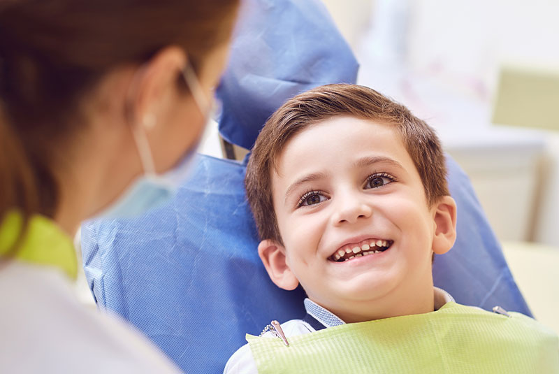 child patient smiling brightly and ready for dental treatment